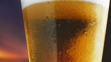 slow-motion-Macro-cold-beer-is-poured-into-a-glass-with-perspiration.-Beer-bubbles-rise-to-the-surface.
